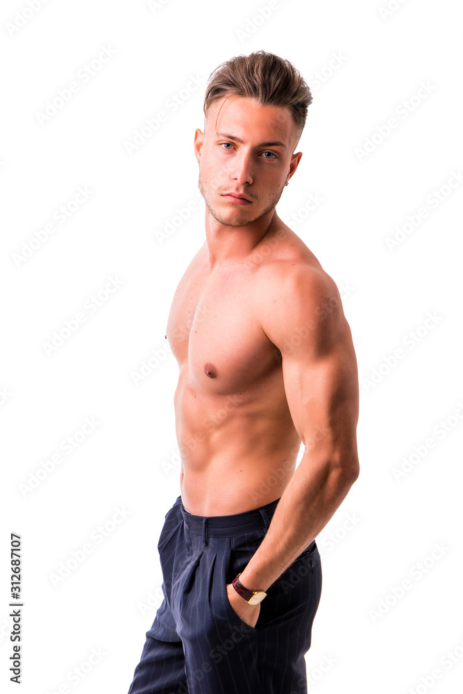 Handsome shirtless athletic young man wearing only pants, with blue eyes, looking at camera in studio shot, isolated on white background Handsome shirtless athletic young man wearing only pants, with blue eyes, looking at camera in studio shot, isolated on white background