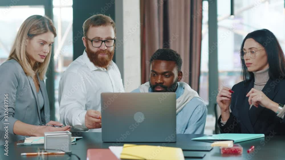 Group of multi-ethnic co-workers gathered together working discuss current issues common tasks african team leader talk with colleague business workplace skilled technology slow motion