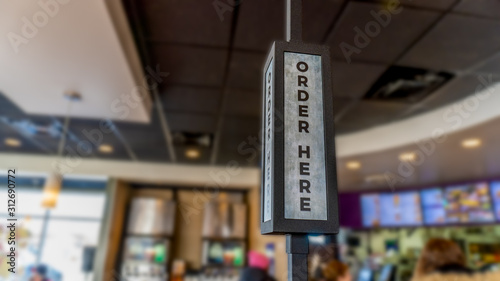 Closeup of a fast food order kiosk sign with a blurred background