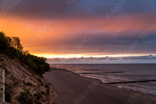 Colorful sunset at the beach of the German island Usedom with cliff coast and the ocean