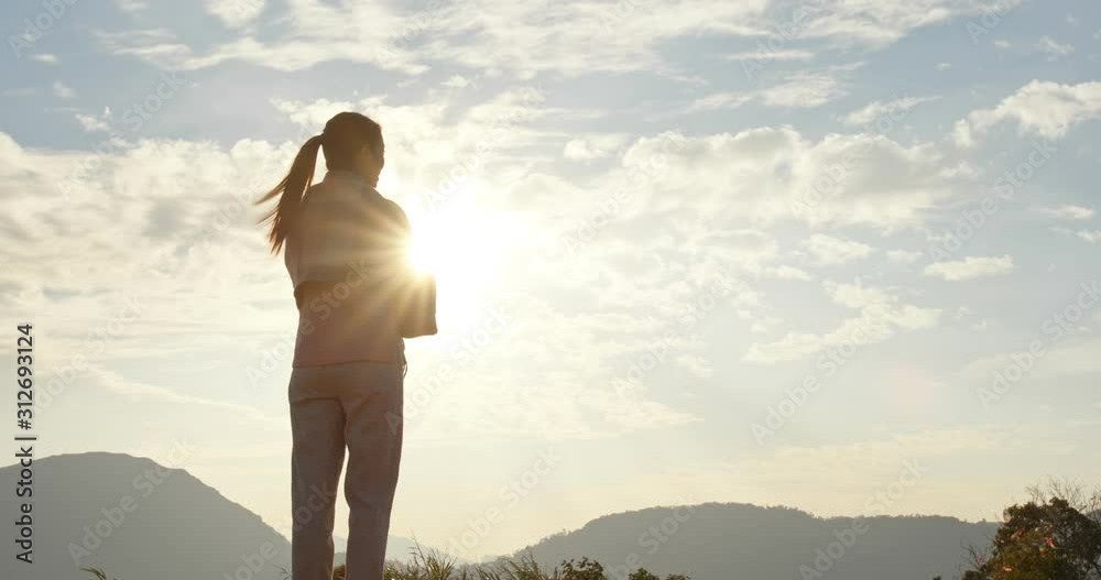 Woman look at the sky with sun flare light