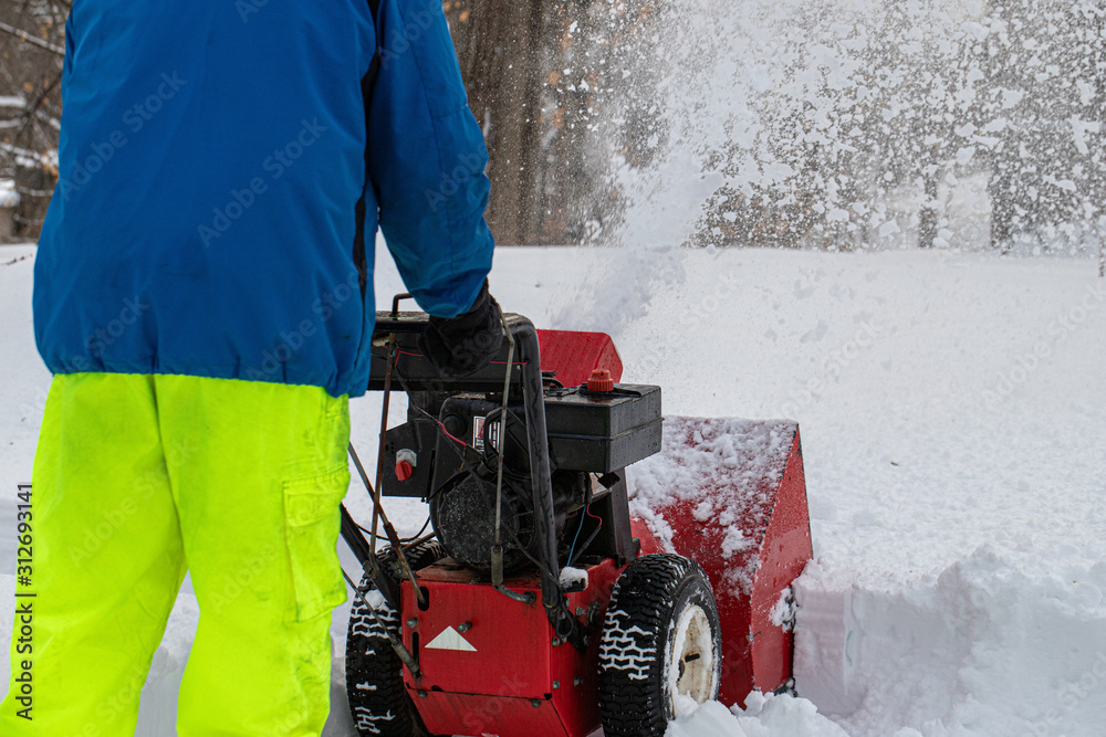 Man pushing snowblower during snowstorm Stock Photo Adobe Stock
