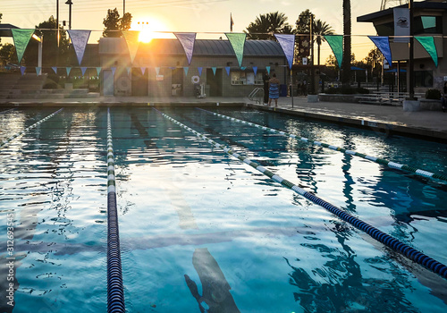 public pool with beautiful sunset reflecting across water