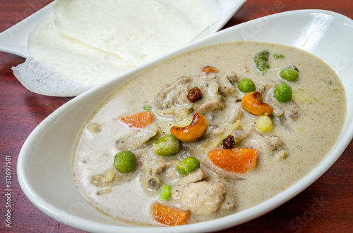 Traditional Chicken Stew in Kerala Style with cashew and vegetables along with Appams.