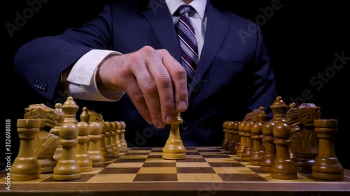 Business Professional Defeats King on Wooden Chess Board