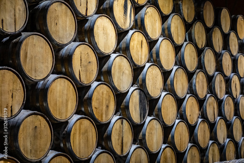Canvas-taulu Huge stack of oak barrels aging tequila in a warehouse in Mexico