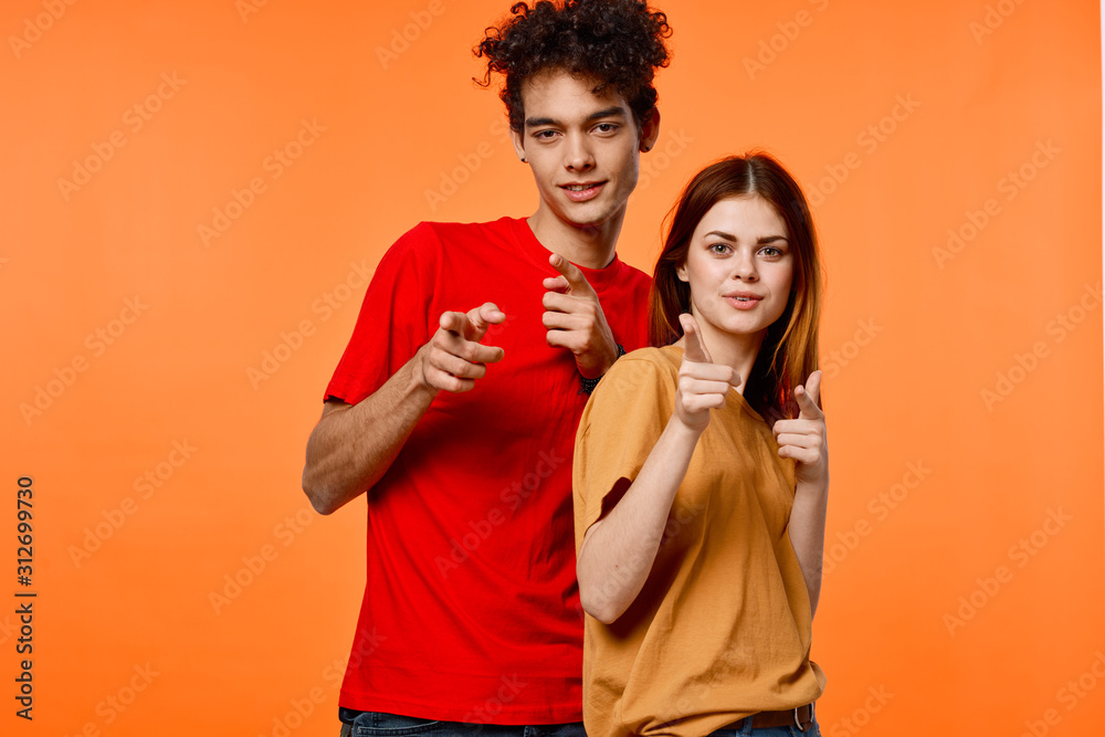 young couple in t-shirts chatting young couple in t-shirts chatting