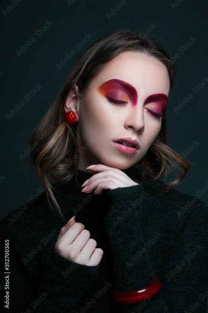 Fototapeta premium fashion beauty portrait of model with modern vogue trendy make up, magazine editorial ready, close up red eye shadows and lipstick, n studio 