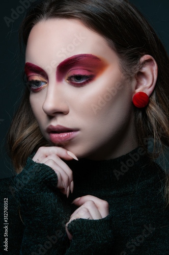 fashion beauty portrait of model with modern vogue trendy make up  magazine editorial ready  close up red eye shadows and lipstick  n studio 