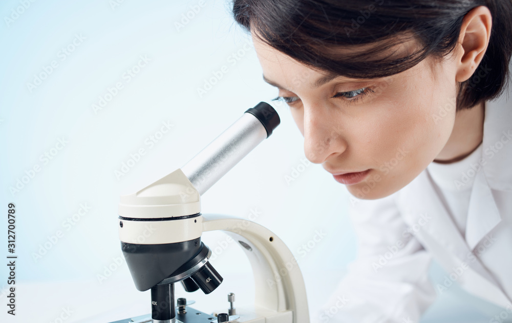 scientist looking through microscope scientist looking through microscope