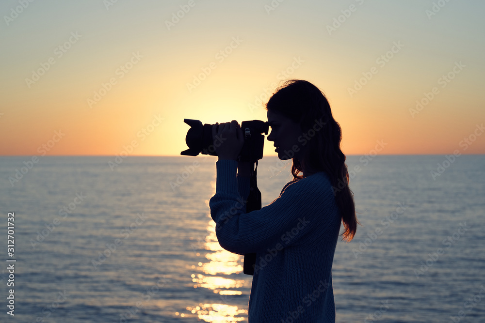 woman silhouette of a photographer at sunset woman silhouette of a photographer at sunset