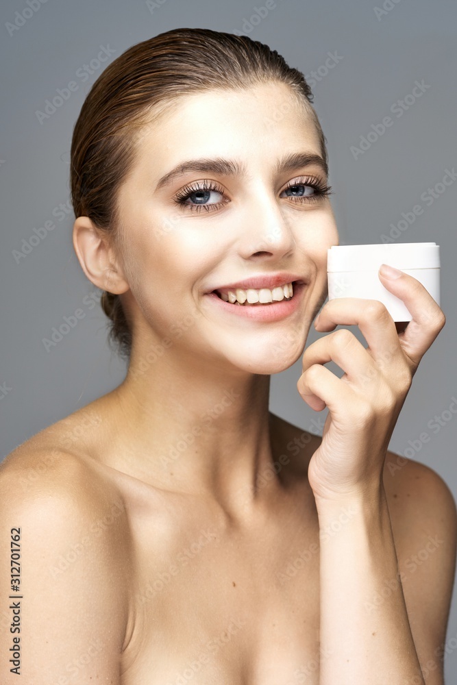 portrait of young woman applying blusher portrait of young woman applying blusher