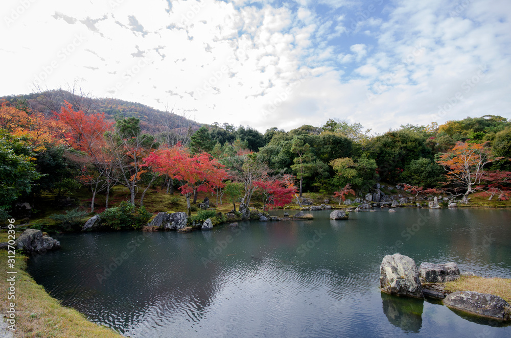 Colorful autumn park and pond in Tenryuji temple garden at Kyoto, Japan.