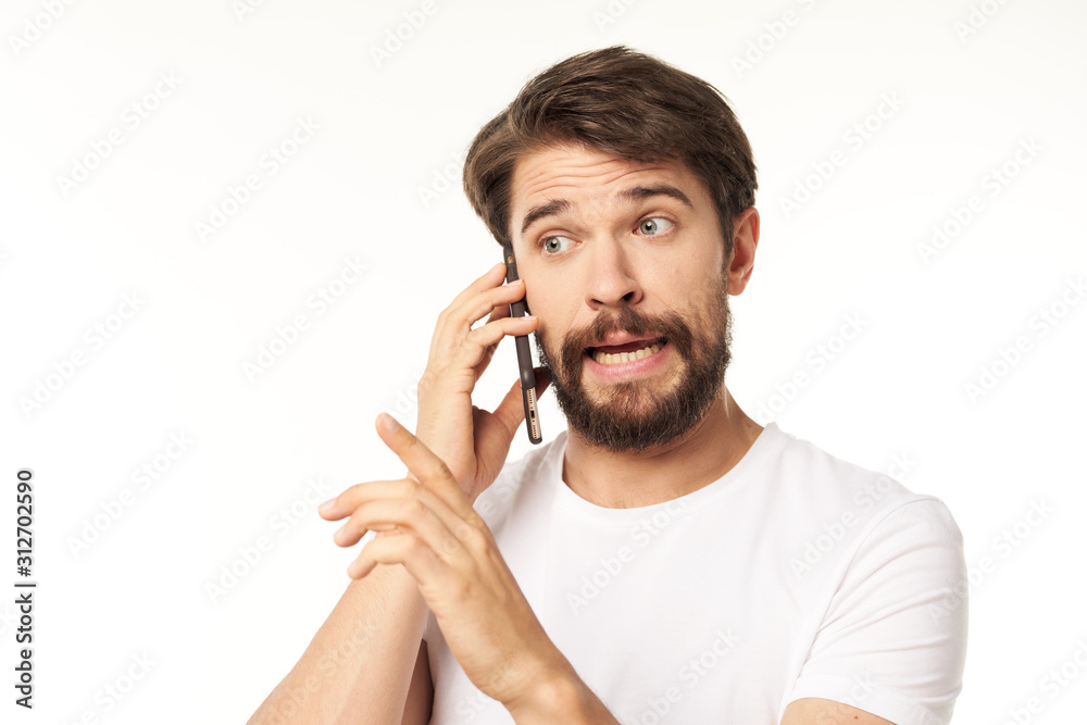 young man talking on the phone isolated on white young man talking on the phone isolated on white