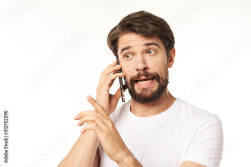 young man talking on the phone isolated on white
