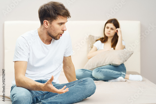 couple sitting on sofa and watching tv