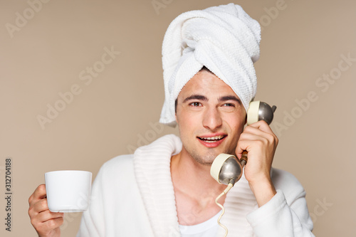 portrait of young man with phone on white background