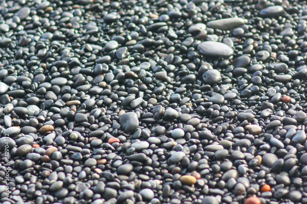 Pebble stones closeup on the shore in the blurry background Pebble stones closeup on the shore in the blurry background
