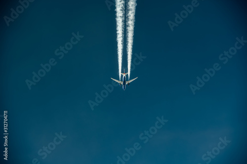 aerial view of a jet creating a contrail © phillips