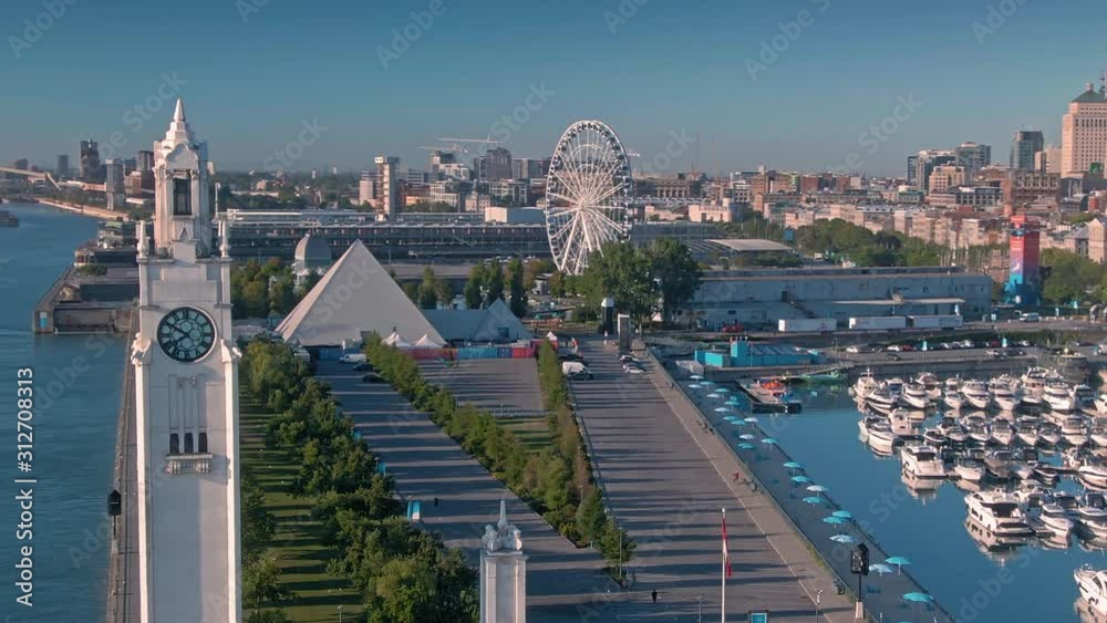 Aerial flying over the clock tower in the Montreal old port, along the St Lawrence river. Montreal, Quebec, Canada. 6 September 2019