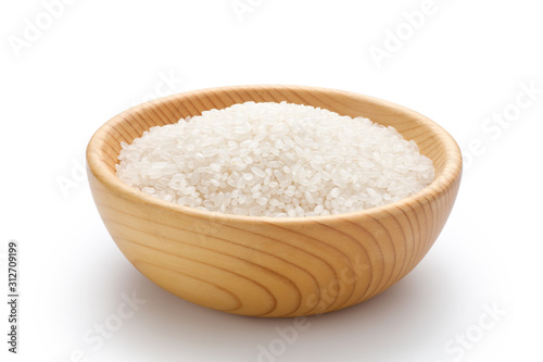 The rice of northeast China in a wooden bowl on white background.