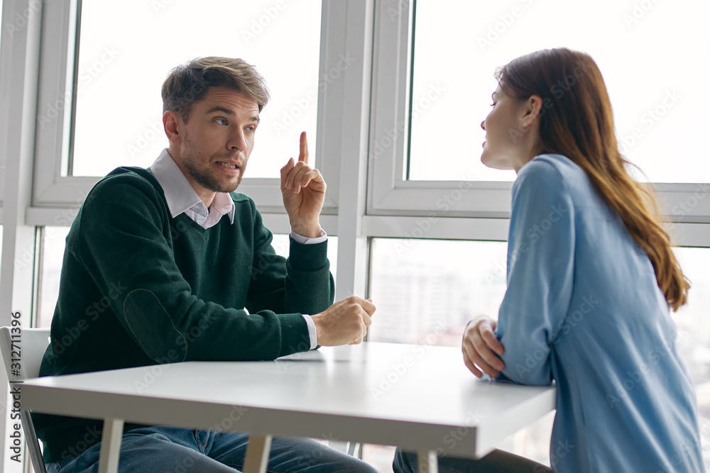 man and woman talking on phone in office man and woman talking on phone in office