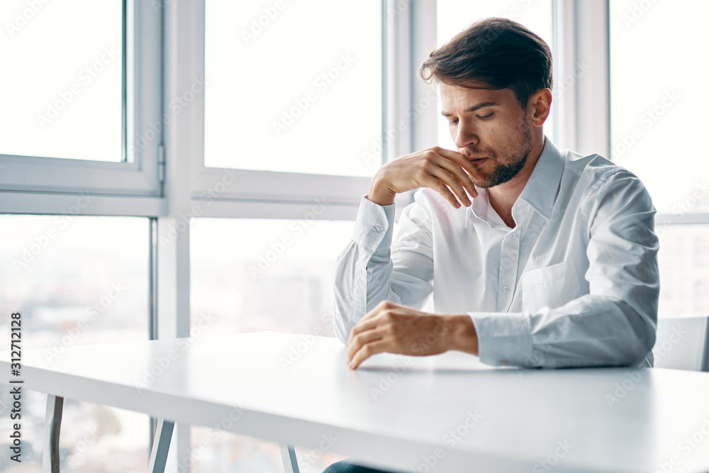 businessman sitting at table in office businessman sitting at table in office
