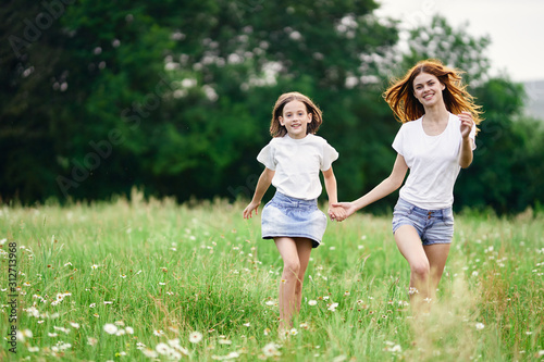 mother and daughter running in the field