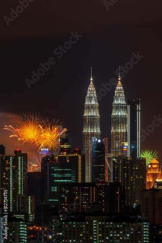 KUALA LUMPUR, MALAYSIA - 1ST JANUARY 2020; Fireworks explode near Malaysia's landmark Petronas Twin Towers during New Year celebrations in Kuala Lumpur.