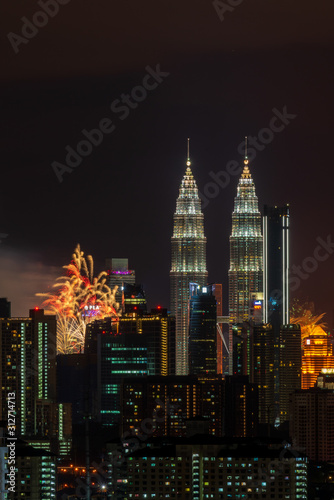 KUALA LUMPUR, MALAYSIA - 1ST JANUARY 2020; Fireworks explode near Malaysia's landmark Petronas Twin Towers during New Year celebrations in Kuala Lumpur.