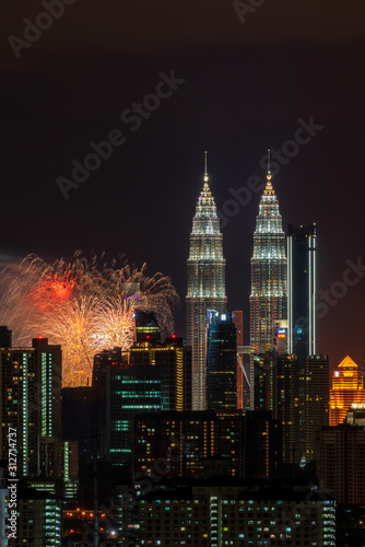 Photography KUALA LUMPUR, MALAYSIA - 1ST JANUARY 2020; Fireworks explode near Malaysia's landmark Petronas Twin Towers during New Year celebrations in Kuala Lumpur