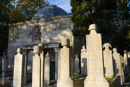 Grave stones and Mausoleum in the Ottoman cemetery at Eyup Sultan Mosque Istanbul photo