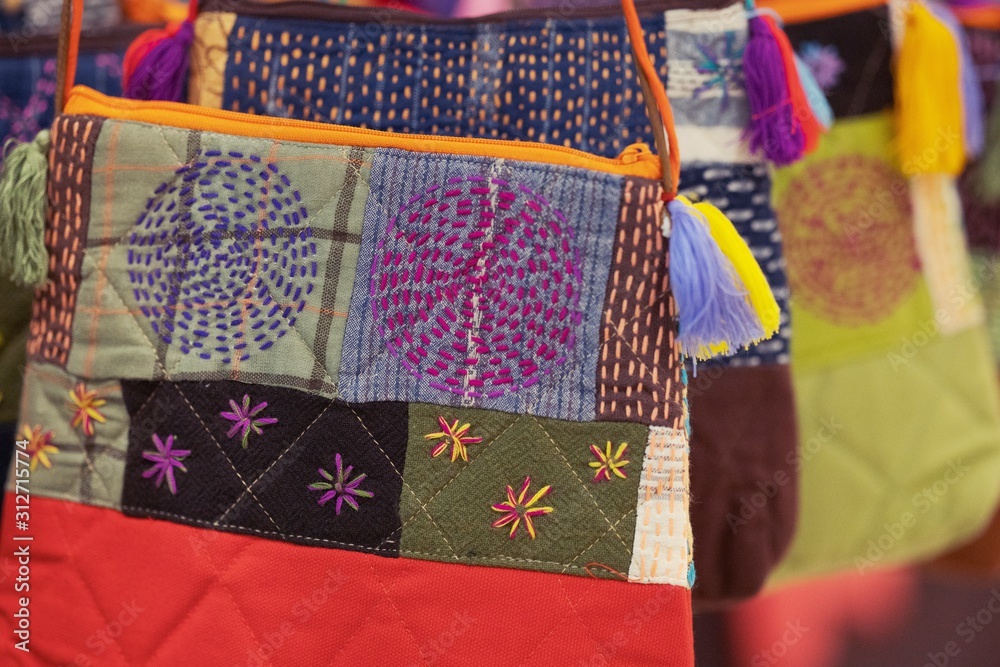Close up of Handicrafts embroidered bag with traditional pattern texture background