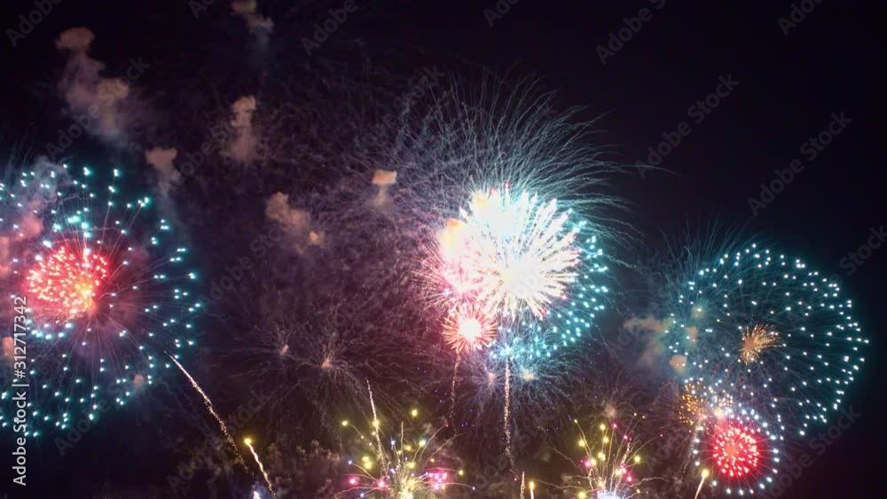 Beautiful abstract colourful Fireworks explode display on sky at night a symbol of celebration in New years anniversary for background