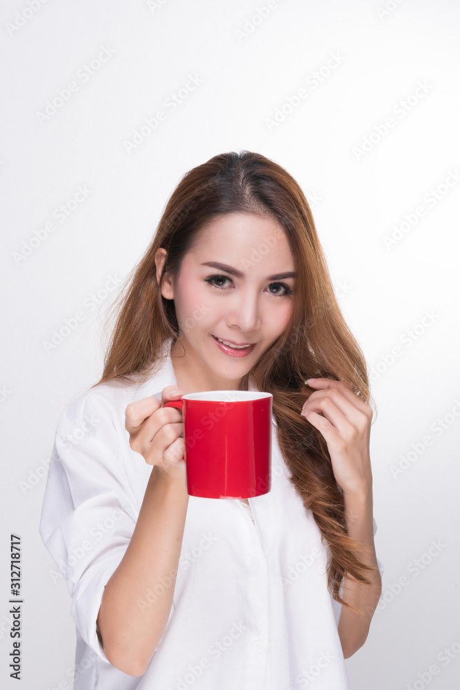 Asian woman portrait with perfect skin and wearing a white shirt in happiness holding red coffee cup isolated on white background. Asian woman portrait with perfect skin and wearing a white shirt in happiness holding red coffee cup isolated on white background.