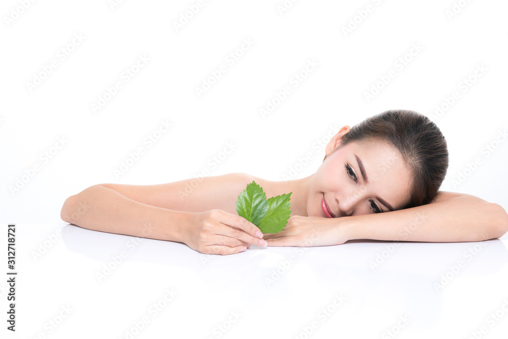 Close-up studio shot, Beautiful young woman with clean fresh skin holding green leaves. Proposing a product. Gestures for advertisement isolated on white background. Close-up studio shot, Beautiful young woman with clean fresh skin holding green leaves. Proposing a product. Gestures for advertisement isolated on white background.