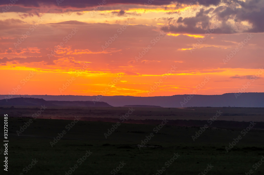 A gorgeous sunset in the plains of Africa inside Masai Mara National Reserve during a wildlife safari
