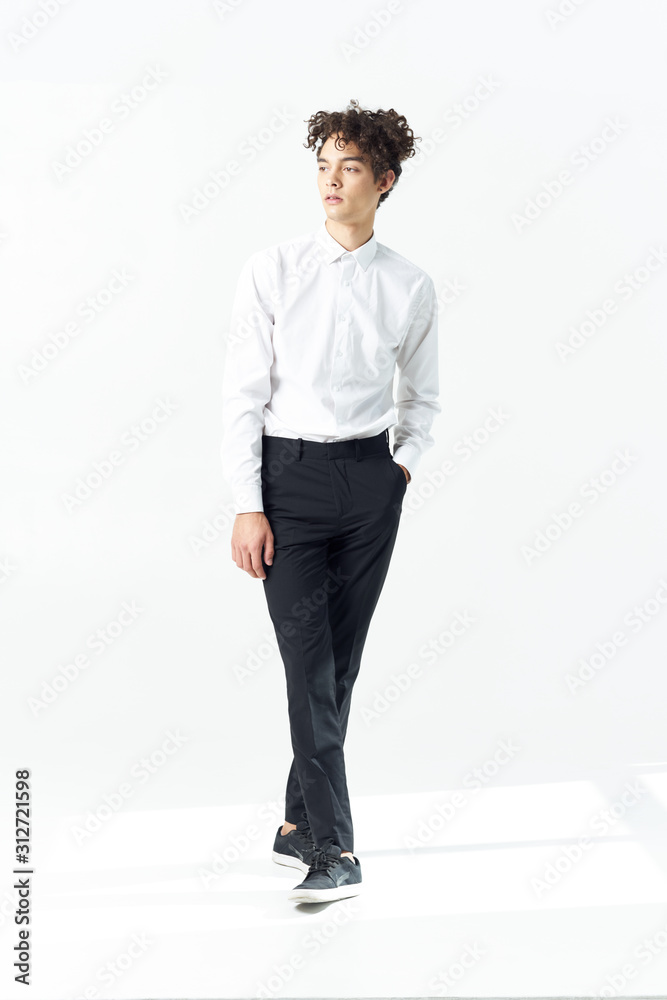 young man standing with his hands in pockets young man standing with his hands in pockets