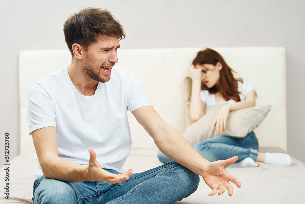 young couple sitting on sofa and watching tv