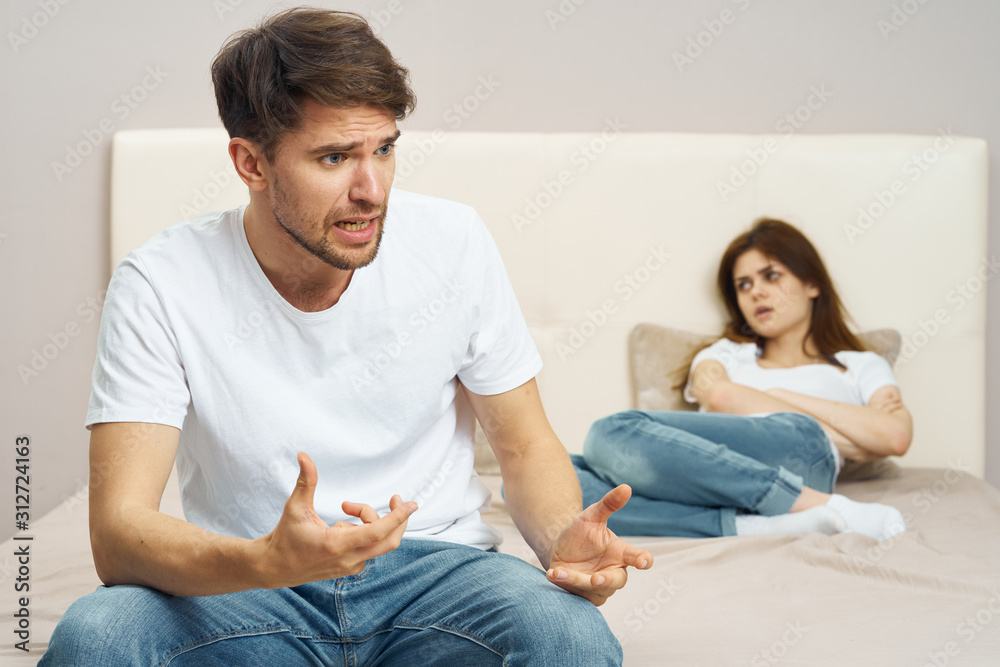couple sitting on sofa and watching tv couple sitting on sofa and watching tv