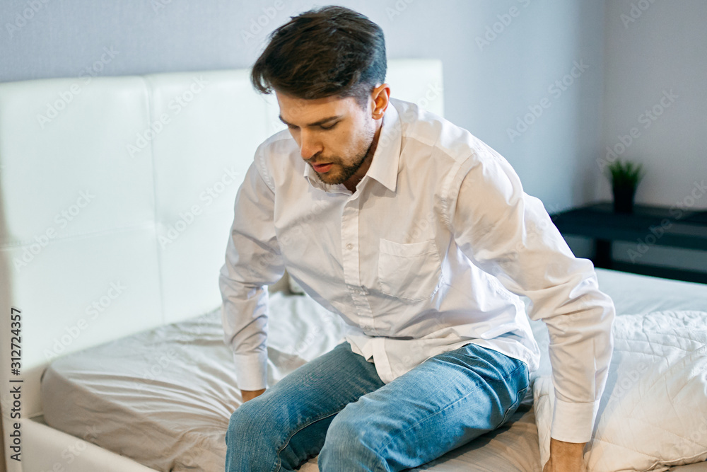 man sitting on sofa and using digital tablet