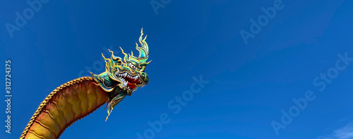Part of Naga head with blue sky background, Wat Phra That Nong Bua, Ubon Ratchathani, Thailand © toonzzz