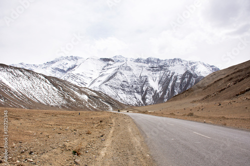 View landscape beside road with Indian people drive car on Srinagar Leh Ladakh highway go to view point of Confluence of the Indus and Zanskar River at Leh Ladakh in Jammu and Kashmir, India in winter