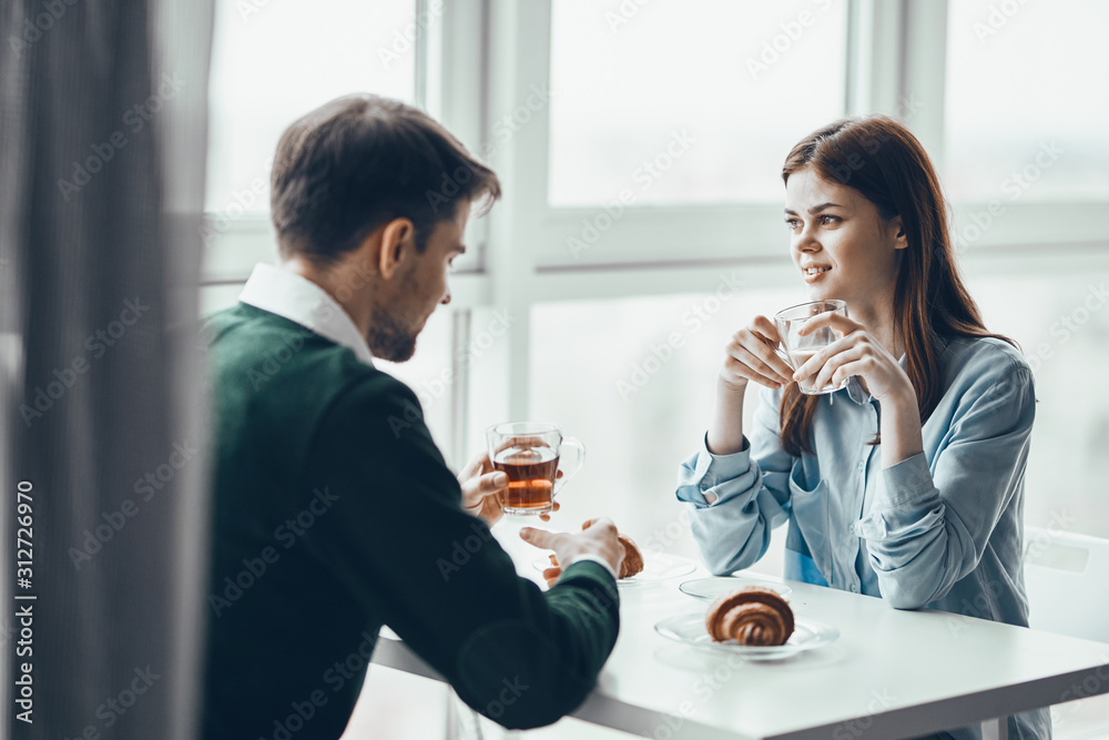 young couple having breakfast in the kitchen young couple having breakfast in the kitchen