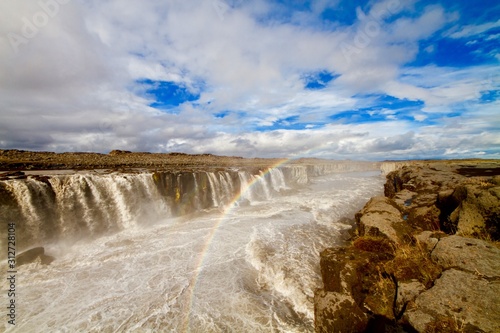 Rainbow over the river that create Dettifoss waterfall in Iceland 