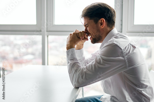 businessman sitting in office and talking on cell phone