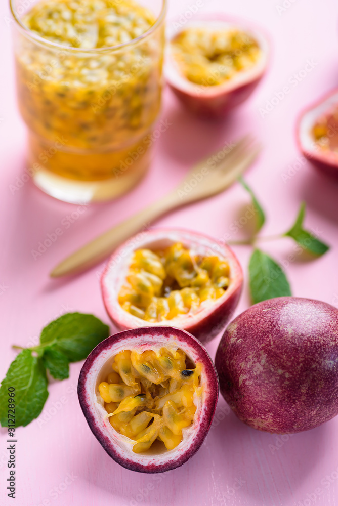 Fresh passion fruit and juice on pink background Fresh passion fruit and juice on pink background