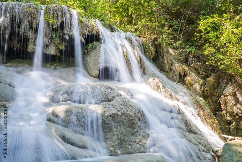 Waterfall and blue emerald water color in Erawan national park. Erawan Waterfall, Beautiful nature rock waterfall steps in tropical rainforest at Kanchanaburi province, Thailand