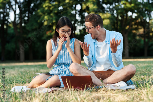 young couple having picnic in park