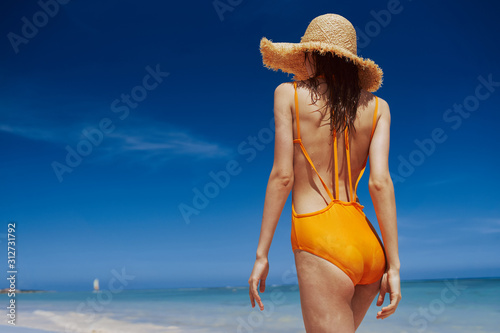 young woman in hat on the beach
